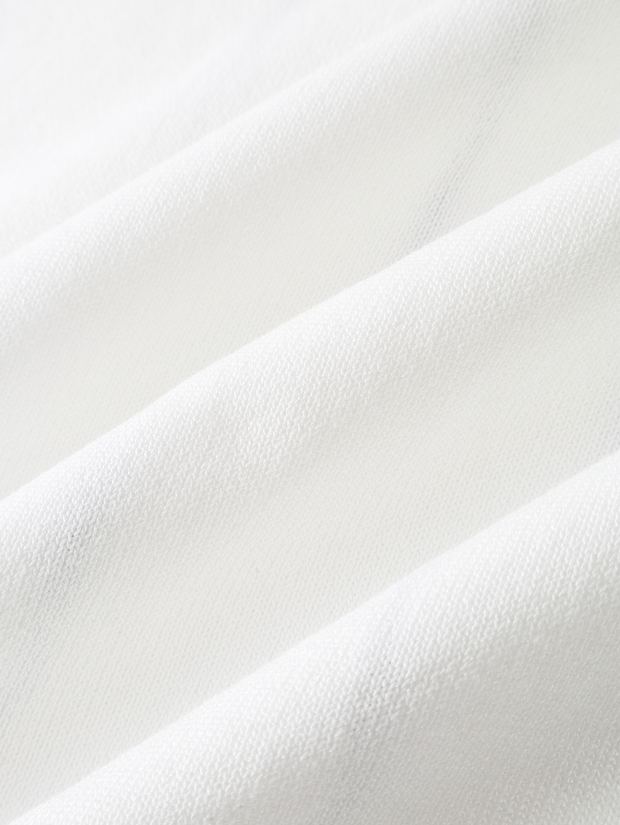 Close-up of the ribbed knit on an ivory polo
