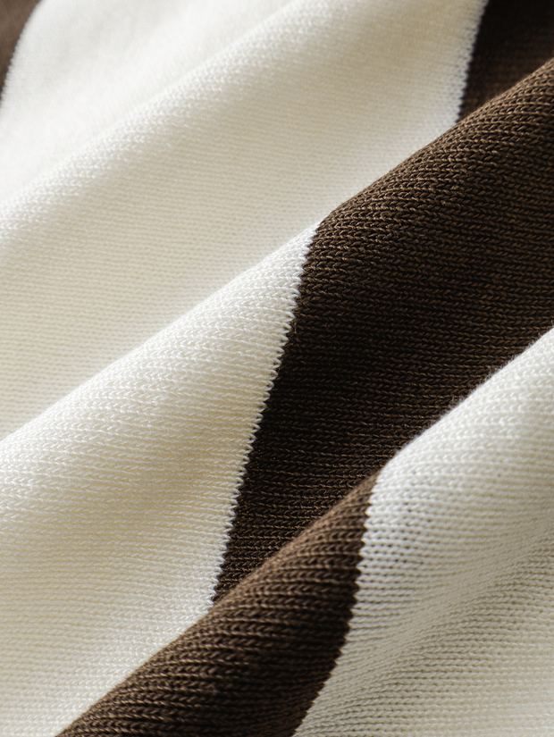 Close-up of the striped knit on a cream and brown polo